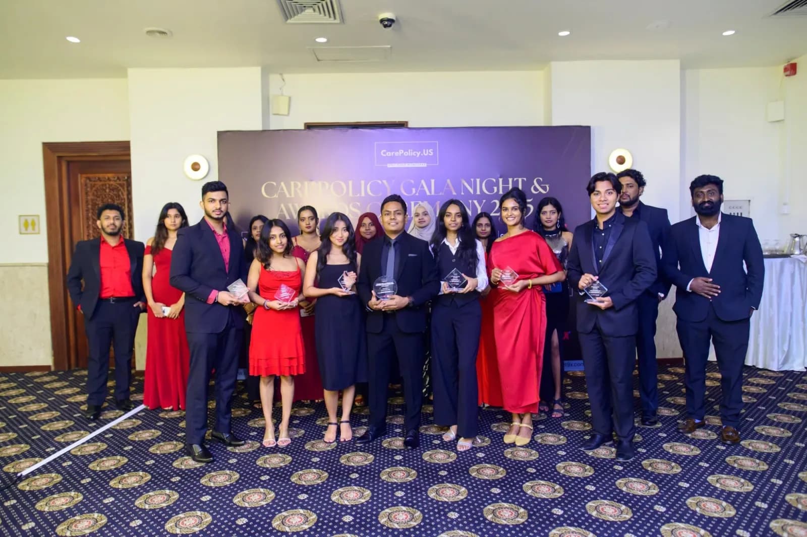 CarePolicy.US team members holding their awards at the 2025 Gala Night and Awards Ceremony.
